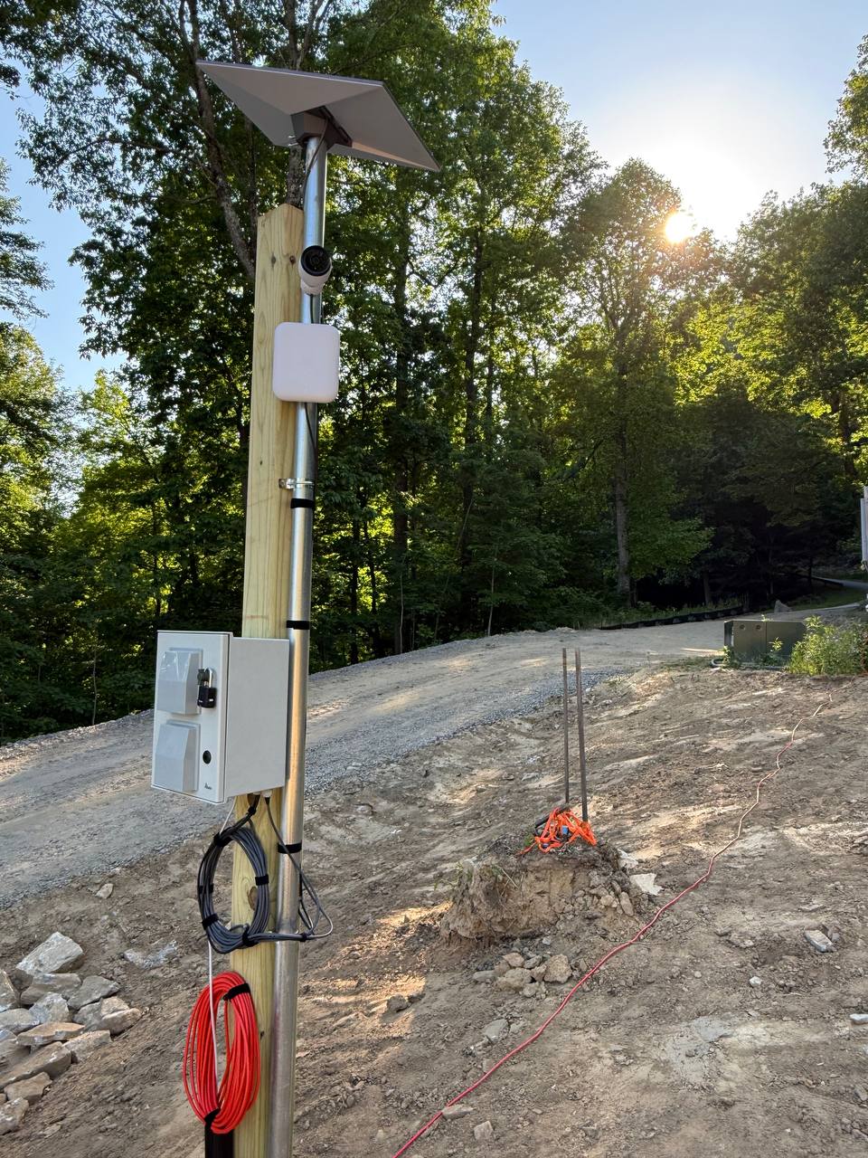 Close-up of the weatherproof enclosure and mounted jobsite connectivity hardware on an active construction site
