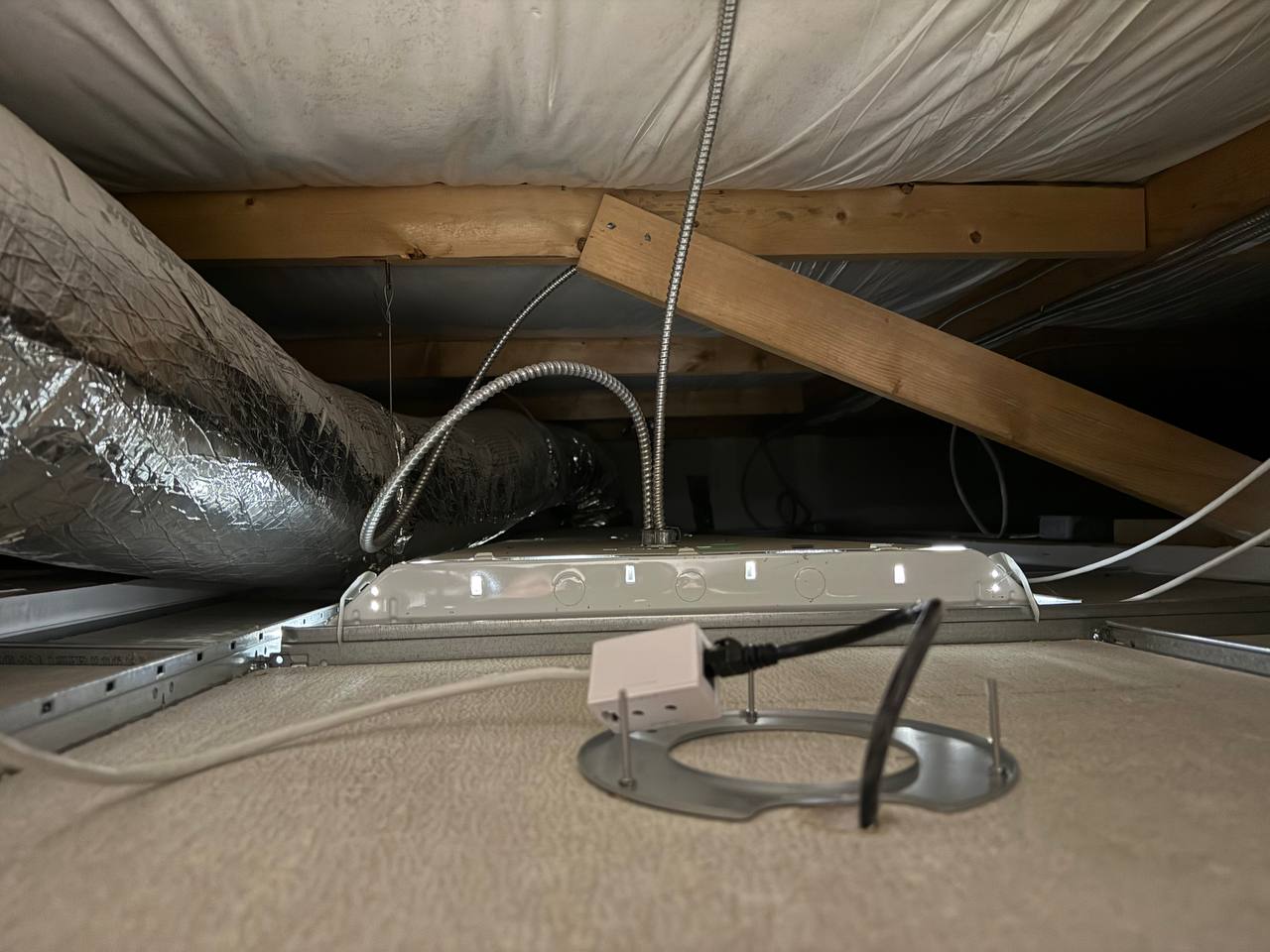 Close-up of UniFi access point installation detail in the metal building