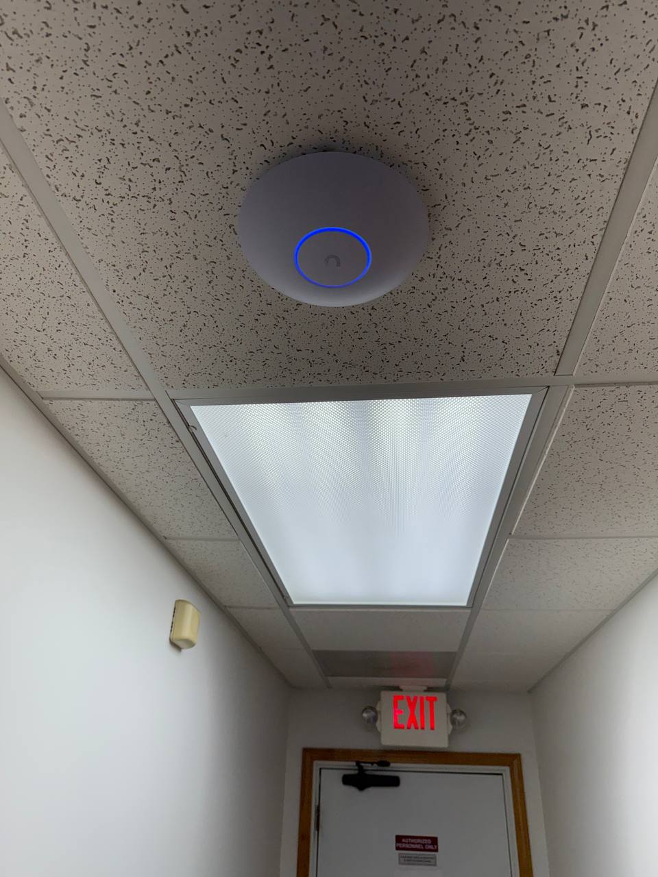 Ubiquiti UniFi access point ceiling-mounted and active in the paving company office